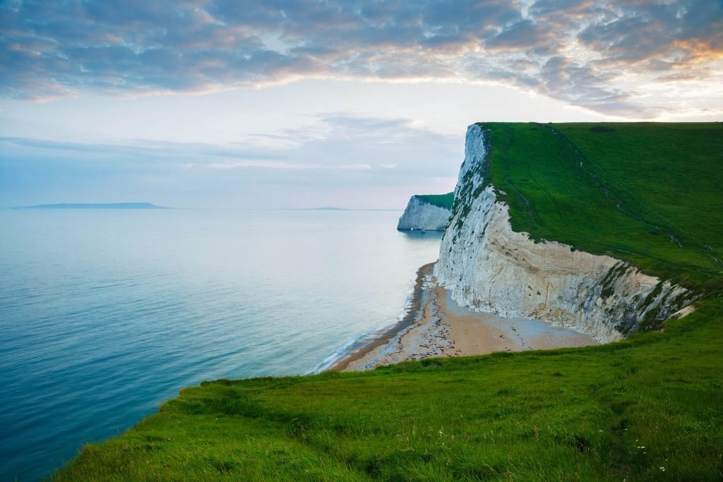 View across the cliffs to Bats Head from the cliffs above Durdle Door beach as the sun goes down for the evening, Dorset, England. Durdle door is one of the many stunning locations to visit on the Jurassic coast in southern England.