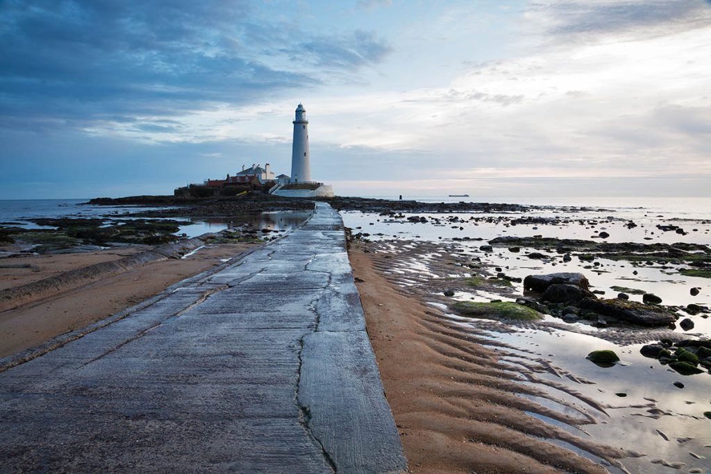 Saint Mary's Lighthouse on Saint Mary's Island, situated north of Whitley Bay, Tyne and Wear, North East England. Seen at sunrise from the beach beside the causeway that runs out to the island. Whitley Bay is situated just north of Newcastle.