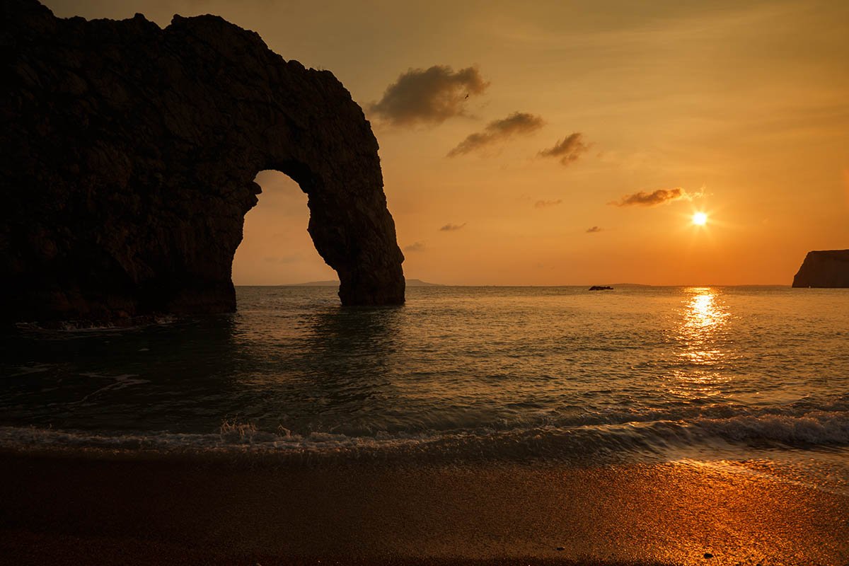 Durdle Door beach as the sun disappears for the day, Dorset, England. Durdle door is one of the many stunning locations to visit on the Jurassic coast in southern England.
