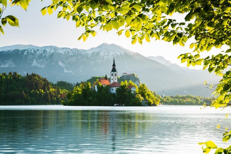 View across Lake Bled to the island church, clifftop castle and Mount Stol in all its spring glory, Slovenia.