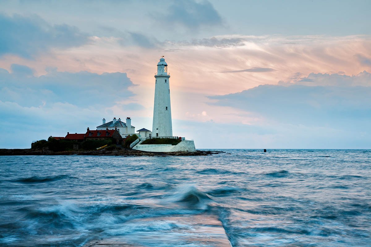 Saint Mary's Lighthouse on Saint Mary's Island, situated north of Whitley Bay, Tyne and Wear, North East England. Seen at sunset from the causeway that runs out to the island. Whitley Bay is situated just north of Newcastle.