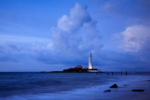 Saint Mary's Lighthouse on Saint Mary's Island, situated north of Whitley Bay, Tyne and Wear, North East England. Seen at dusk from the beach beside the causeway that runs out to the island. Whitley Bay is situated just north of Newcastle.