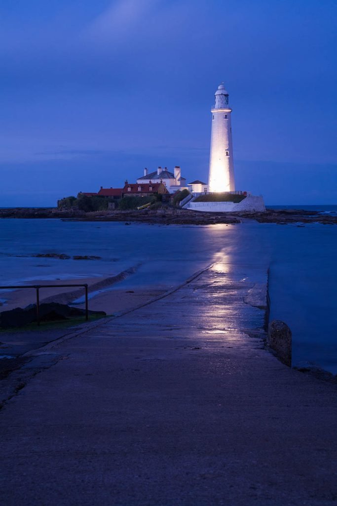 Saint Mary's Lighthouse on Saint Mary's Island, situated north of Whitley Bay, Tyne and Wear, North East England. Seen at dusk from the the causeway that runs out to the island. Whitley Bay is situated just north of Newcastle.