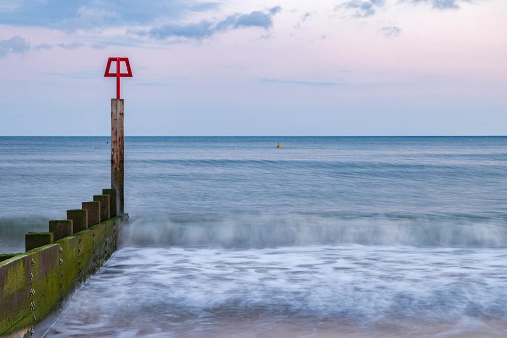 Bournemouth beach and groyne at sunset, Dorset, England