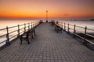 The old cobbled Banjo Jetty at sunrise in Swanage, Dorset, England.