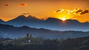 View at sunrise from Rantovše hill across to Sveti Tomaz nad Praprotnim (church of Saint Thomas) and the Kamnik Alps, Slovenia.