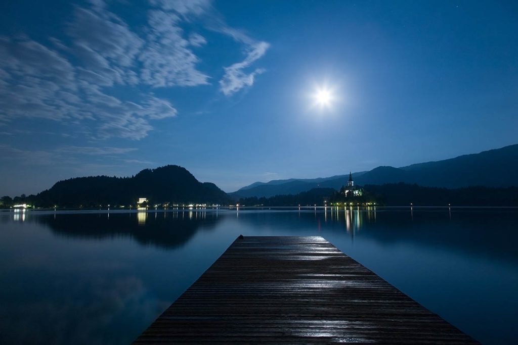 Supermoon visible over the beautiful island church of the assumption of Mary, Lake Bled, Slovenia. Taken on the evening of Sunday June 23rd 2013 when the moon was full.