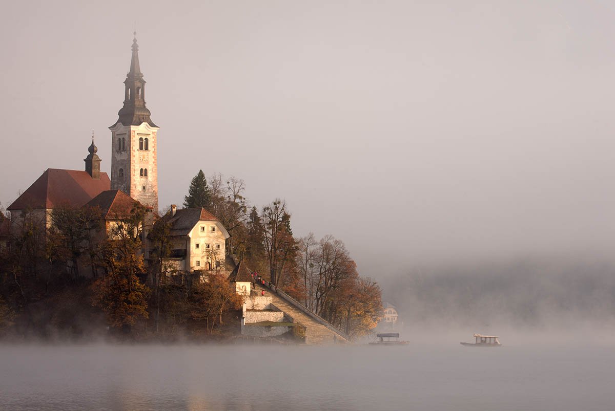 The famous Island church enshrouded in mist over Lake Bled.