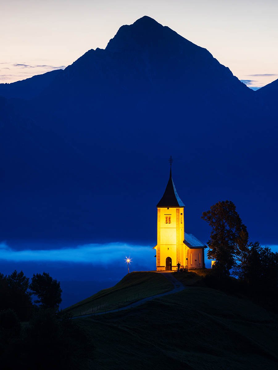 Jamnik church of Saints Primus and Felician at dawn, perched on a hill on the Jelovica Plateau, Slovenia.