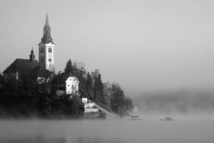 The famous Island church enshrouded in mist over Lake Bled.