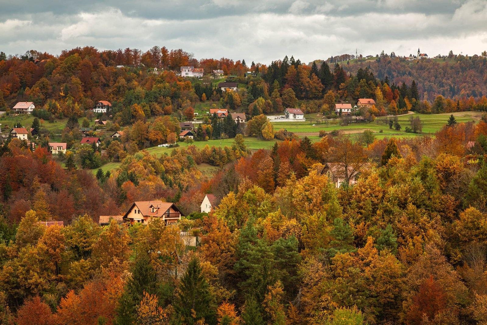 Autumn colours. View across the village of Volavlje to the church of Saint Nicholas in Jance, Slovenia. This is the eastern part of the Ljubljana Municipality.