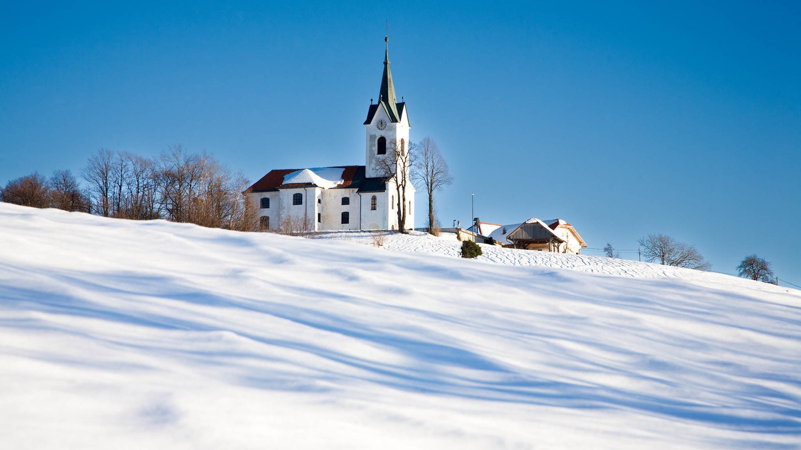 Winter scene of the church of Saint Marjeta in Prezganje in the Jance hills to the east of Ljubljana, Slovenia.