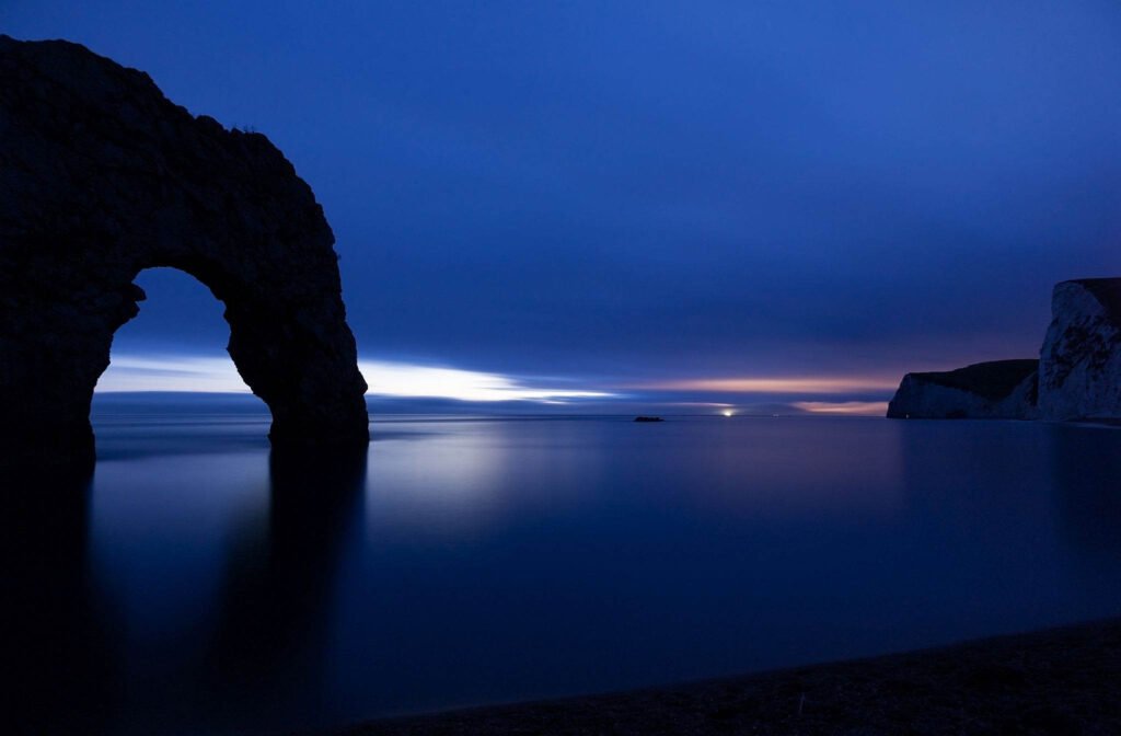 Close up of Durdle Door as the last wisp of light disappears over the horizon at dusk, Dorset, England. Durdle door is one of the many stunning locations to visit on the Jurassic coast in southern England.